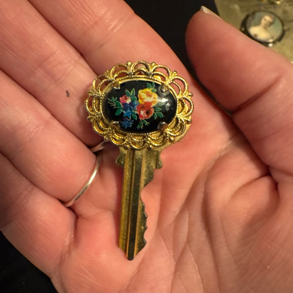 Vintage Floral Gold Key Brooch with Black Background